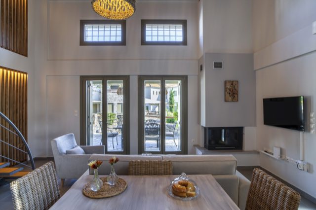 The dining table, the fireplace and the doors to the patio