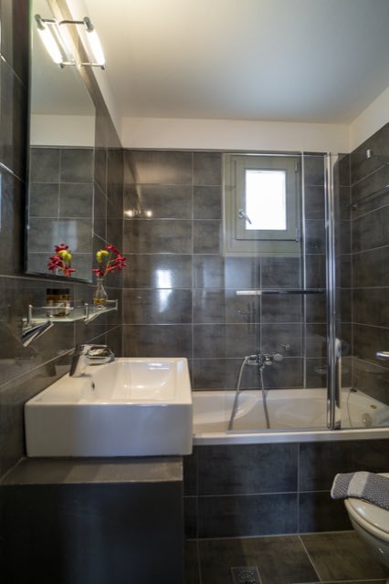 The ground-floor bathroom, bath and shower screen