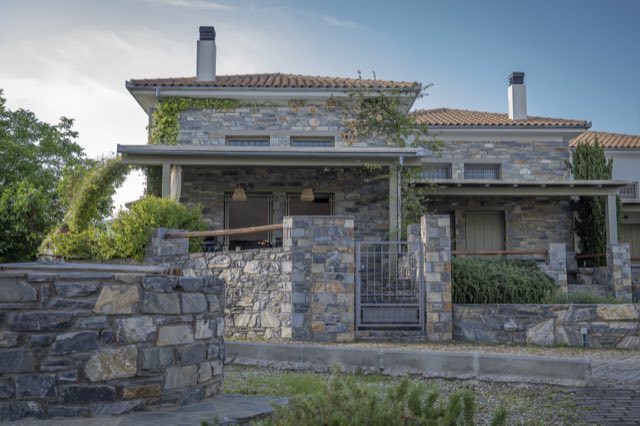 The villa behind its low stone wall