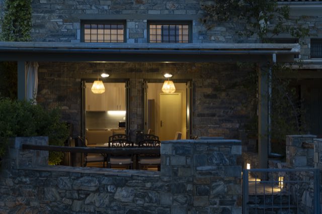 The villa&rsquo;s porch lit up after dark