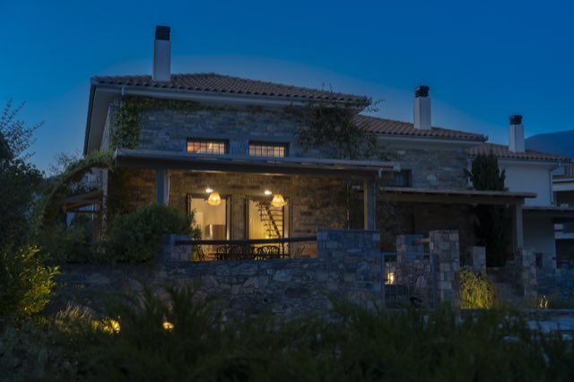 The villa under a deep-blue evening sky