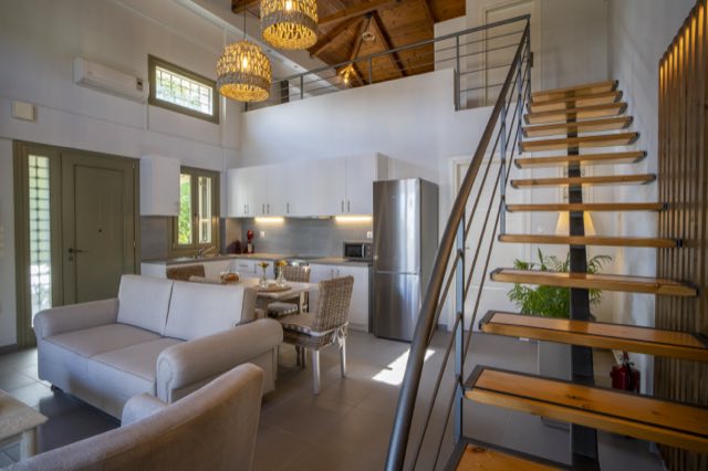 The open-tread staircase rising from the living room to the loft
