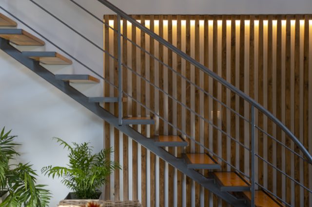 The staircase against the lit timber wall