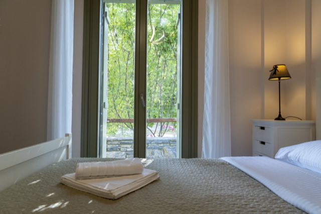 The main bedroom, its door open to the garden