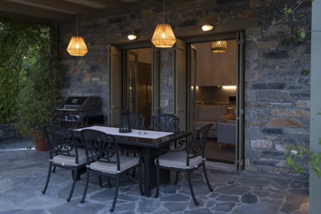 The covered patio at dusk, lanterns lit