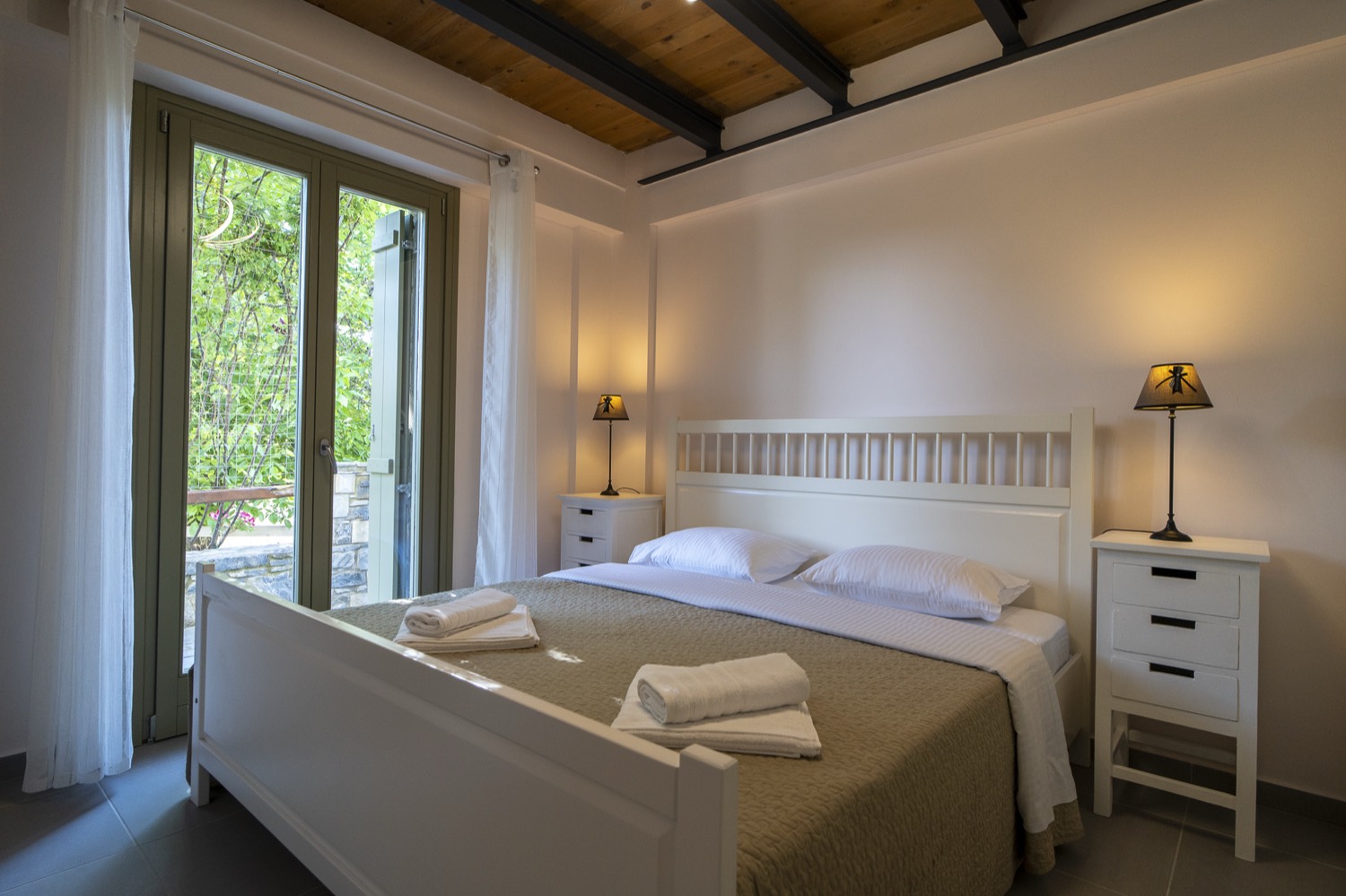 The main bedroom, with a king bed and garden view