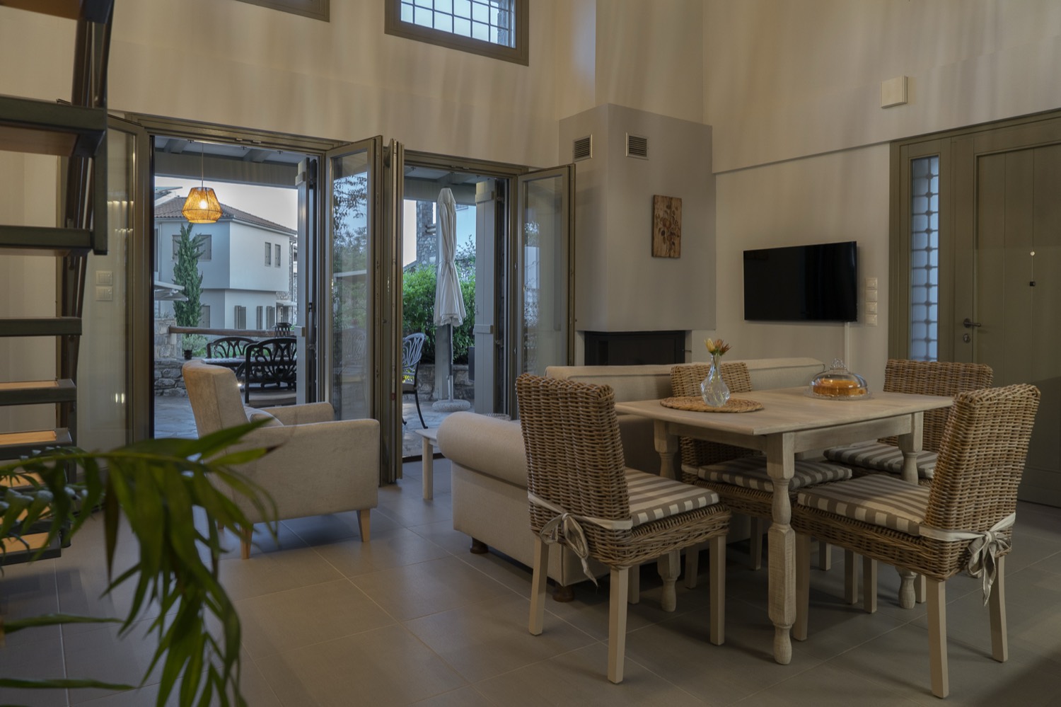 Living and dining room with the fireplace and doors open to the patio