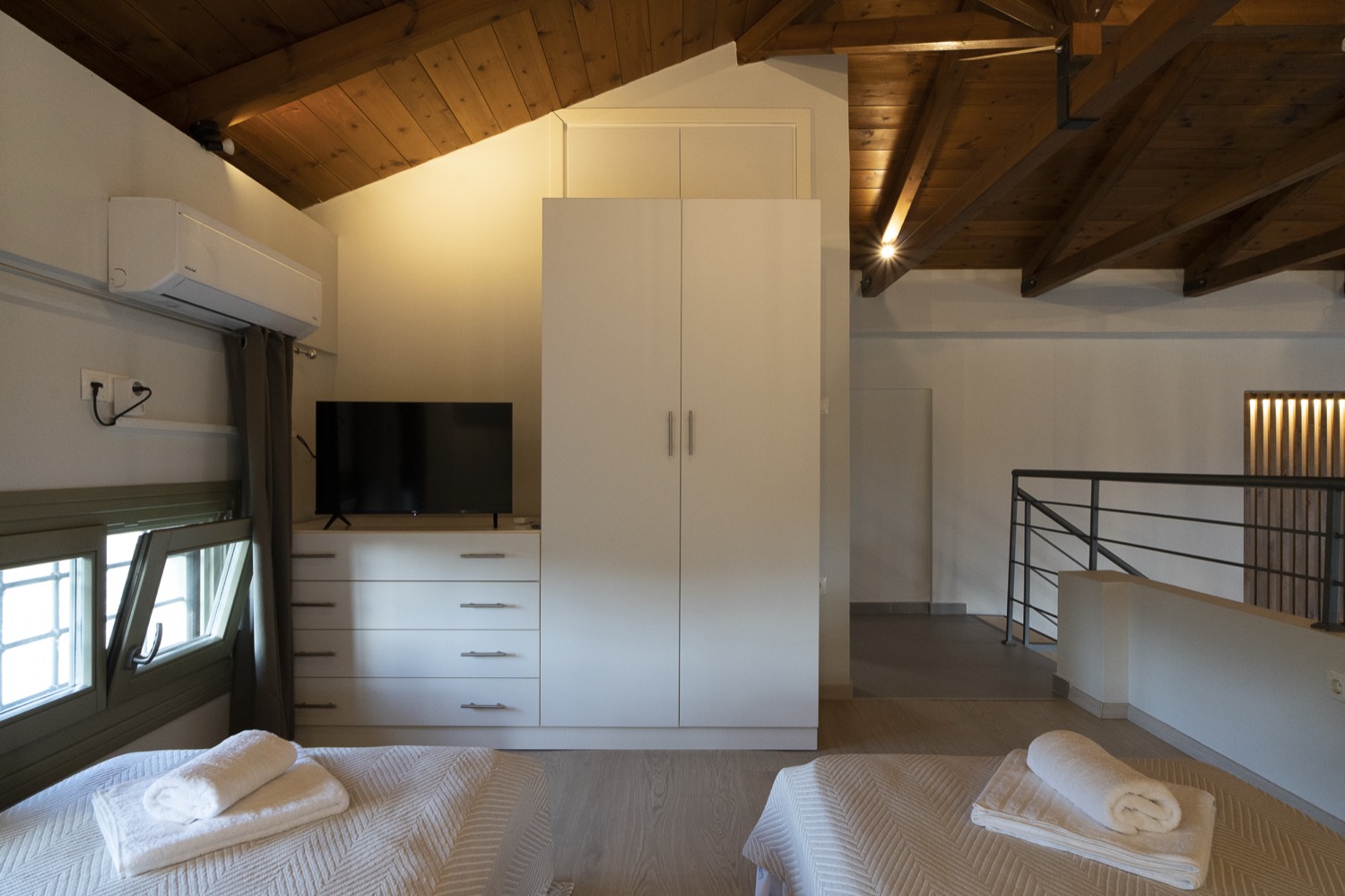 The loft bedroom under the timber roof
