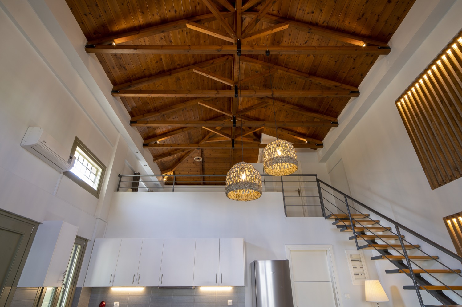 The open timber roof and the staircase to the loft