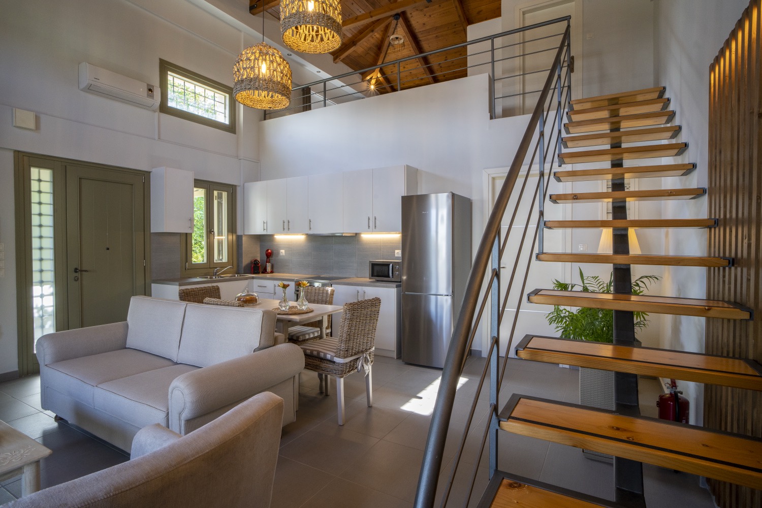 The open-tread staircase rising from the living room to the loft
